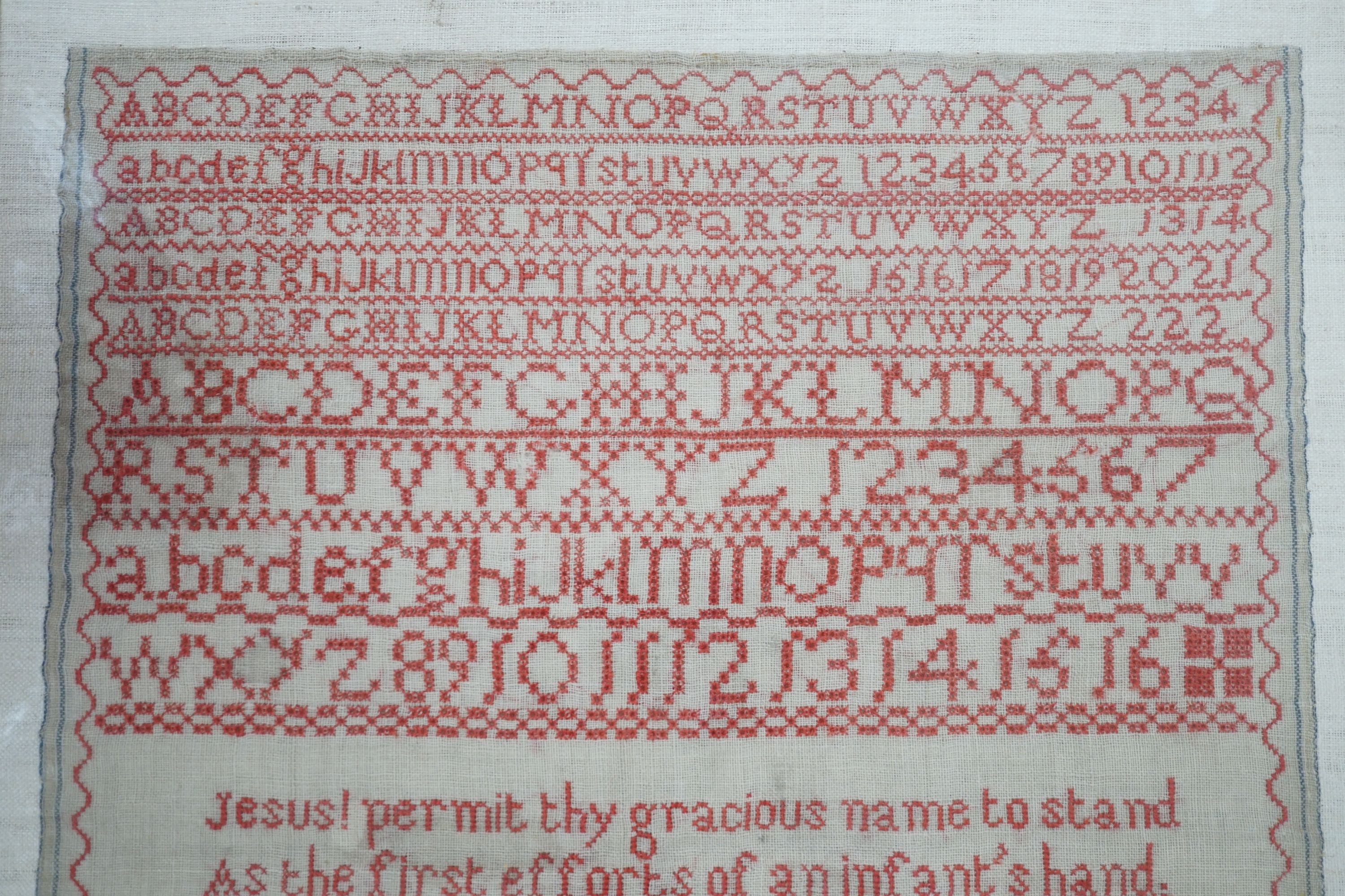 19th century red cross stitch sampler by Ann Reynolds, dated 1818, 34 cms wide x 42 cms high.
